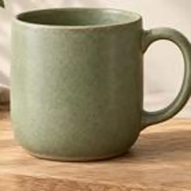 A small, pixelated photo of a glazed ceramic mug
